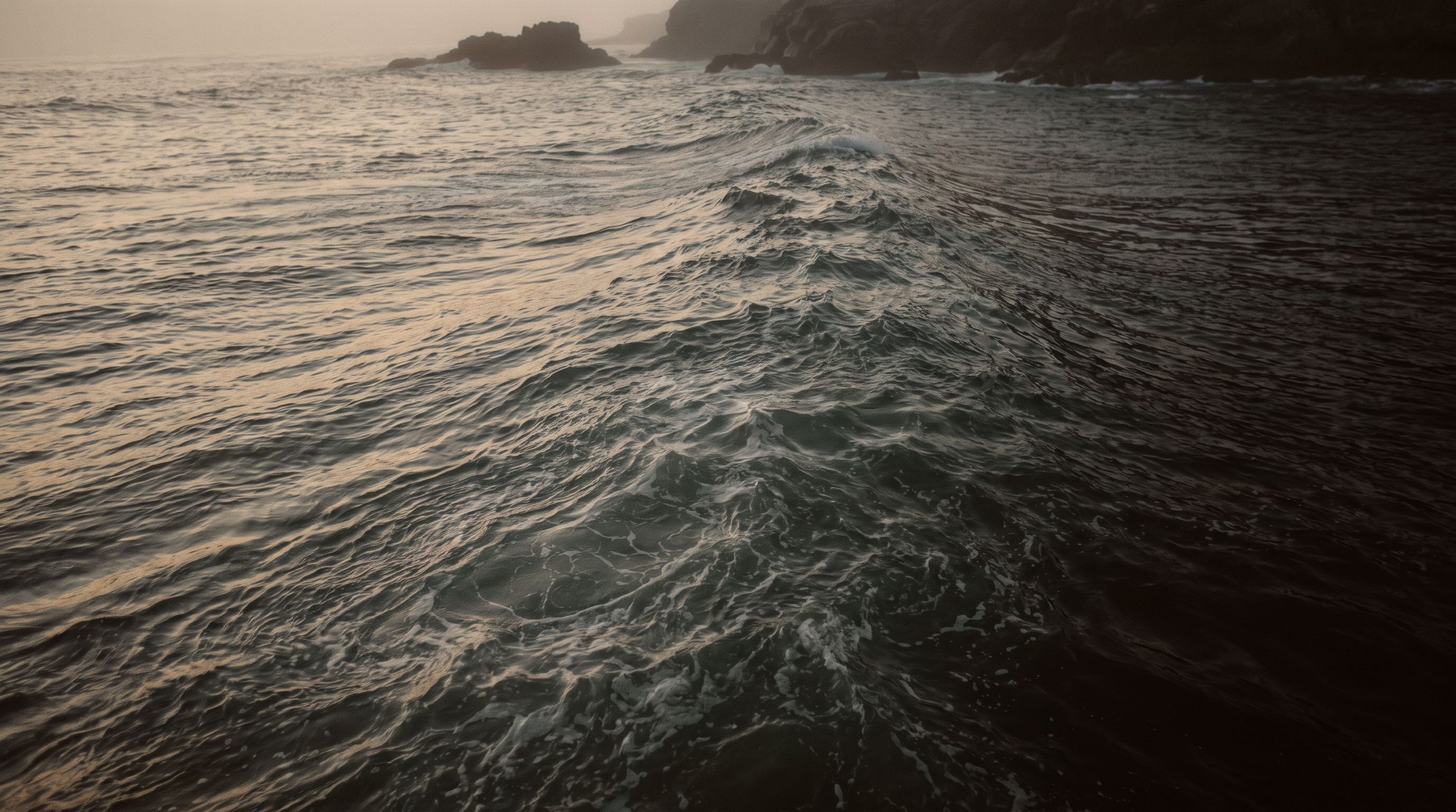 Cold Atlantic water near a rocky New England shore at dusk
